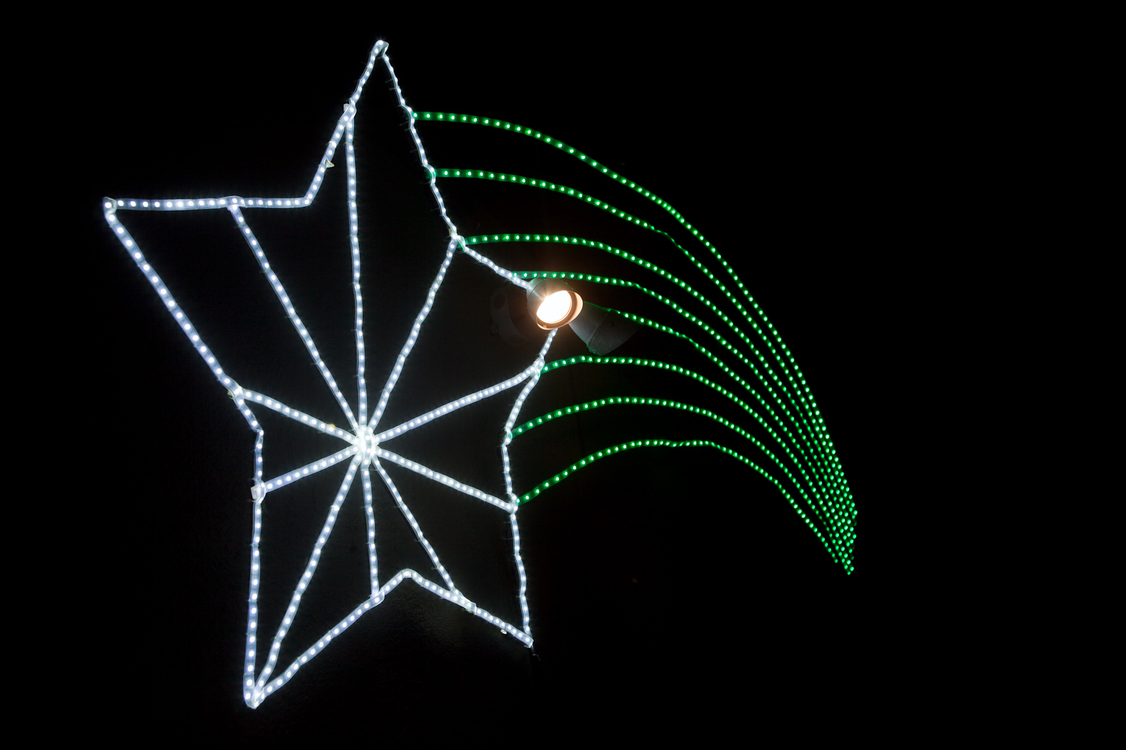 Custom LED shooting star installation — multicolor LEDs mounted above the reception dance area