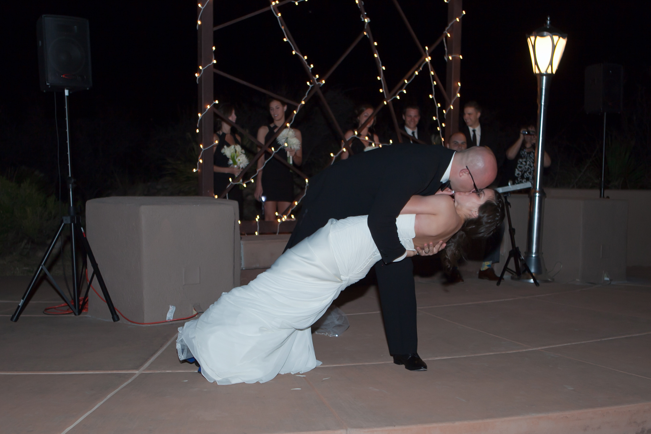 First dance closing dip — the choreographed final move, with custom lamppost visible at right